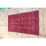 A Bokhara wool rug, worked with rows of gulls against a red ground,