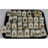 A collection of 28 crested china model cheese dishes and bases, to include London, Cheltenham, Mold,