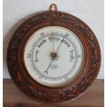 A Stanley of London carved oak aneroid barometer,