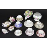 A Hammersley bone china three piece miniature tea set, decorated with flowers,
