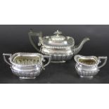 A silver three piece batchelors tea service, William Neale, Sheffield 1897, of low, rounded form,