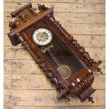 A late 19th century walnut Vienna regulator, with radially gadrooned brass dial,