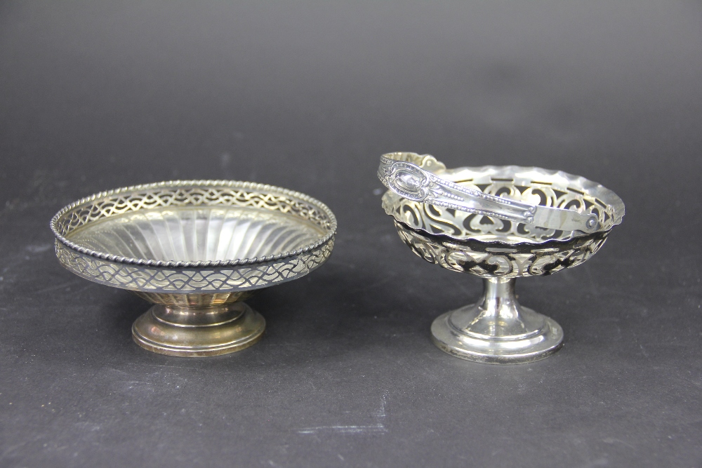 A silver swing handled bowl, Samuel M Levi, Birmingham 1908, of pierced pedestal form, 10.