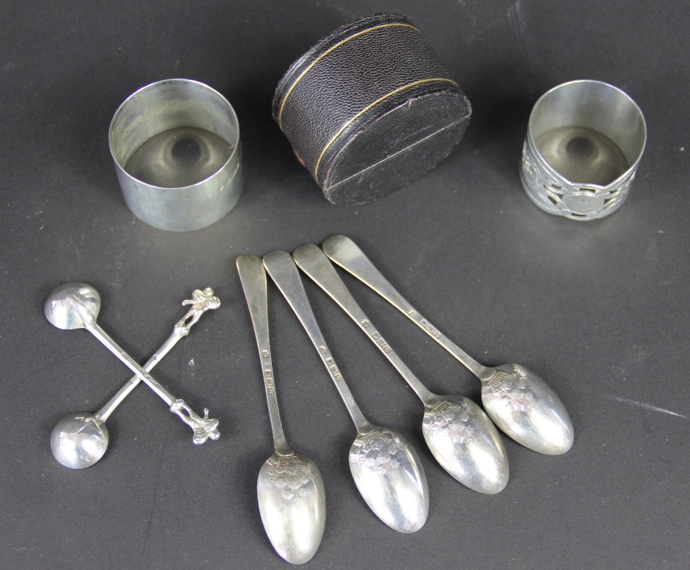 A selection of silver to include; two silver napkin rings, one engraved 'Joan', a napkin ring case,