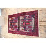 A Baluch wool ground prayer rug, worked with geometric buildings,