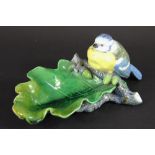 A 19th century Minton Majolica nut dish modelled with a blue tit, seated upon an oak leaf,