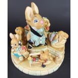 Seven Pendelfin rabbits raised on a stepped stand, to include; Oliver, Snuggles Awake, Toy Tot,