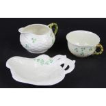 Three pieces of Belleek, to include; a shamrock and ozier moulded cup and milk jug,