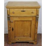 A Victorian pine cabinet, with drawer and cupboard door on bracket feet,