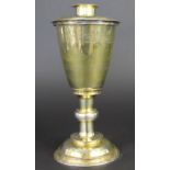 An unmarked mid 16th century silver gilt chalice and paten,