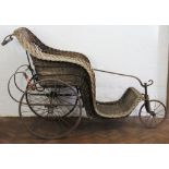 A late Victorian bath chair by Carters Ltd London, with wicker seat and spring carriage, (a/f),