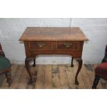 An 18th century and later walnut low boy, with herringbone inlaid top and two drawers on later legs,