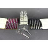 A cased set of six silver handled side knives and another cased similar set,