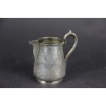 An Indian white metal jug, decorated throughout with many figures - in a tavern, bathing,