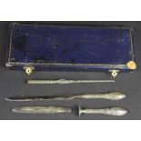 A French four piece silver writing set, comprising letter opener, seal, quill and needle case,