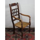 A 19th century stained beech rush seat country kitchen chair