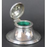 A silver desk inkwell, Chester 1905, of tapering form, the hinged cover with spherical knop,