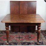 An early Victorian mahogany extending dining table, with three spare leaves,