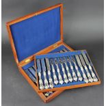 A late Victorian set of twelve pairs of silver handled dessert knives and forks, with plated blades,