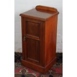 A late Victorian walnut bedside pot cupboard, on plinth base, with label verso for W. H.