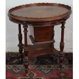 A Victorian inlaid mahogany oval work table, with gallery top and under tier, on turned legs,