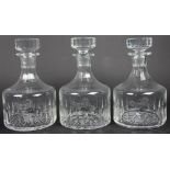A set of three glass decanters and stoppers, each etched with an armorial of a horse,