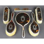 A George V silver and tortoiseshell six piece dressing table set,