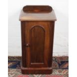A Victorian mahogany pot cupboard, with panelled door, on plinth base,
