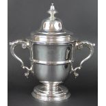 A silver two handled trophy and a cover Edward Barnard & Sons Ltd and Walter and John Barnard,