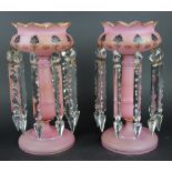 A pair of Victorian pink glass table lustres, with gilt detailing and cut glass drops,
