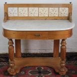 A Victorian birch wash stand, with tile back and marble top, on turned legs,
