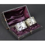 A pair of cased silver napkin rings, Rupert Favell, London 1891,