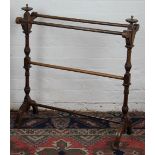 A Victorian oak towel rail, with turned and fluted uprights, on reeded legs,