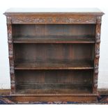 A late Victorian carved oak dwarf open bookcase, with three shelves, on plinth base,