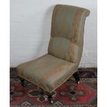 A Victorian ebonised nursing chair, with striped floral upholstery, on turned legs,