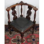 A late 19th century carved oak corner chair,
