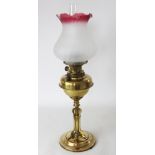 A late Victorian brass oil lamp, with later frosted glass shade,