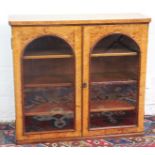 A Victorian birds eye maple table cabinet, with two glazed doors enclosing three adjustable shelves,