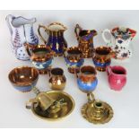 A collection of copper lustre decorated jugs, to include relief moulded and enamelled examples,