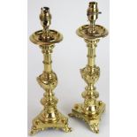 A pair of late 19th century French lacquered brass lamps, modelled as alter sticks,