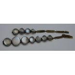 A moonstone set bracelet, designed as eleven graduated, oval moonstones,