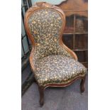 A Victorian carved walnut nursing chair,