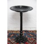 A cast iron bird bath, with dished circular top on pierced base,