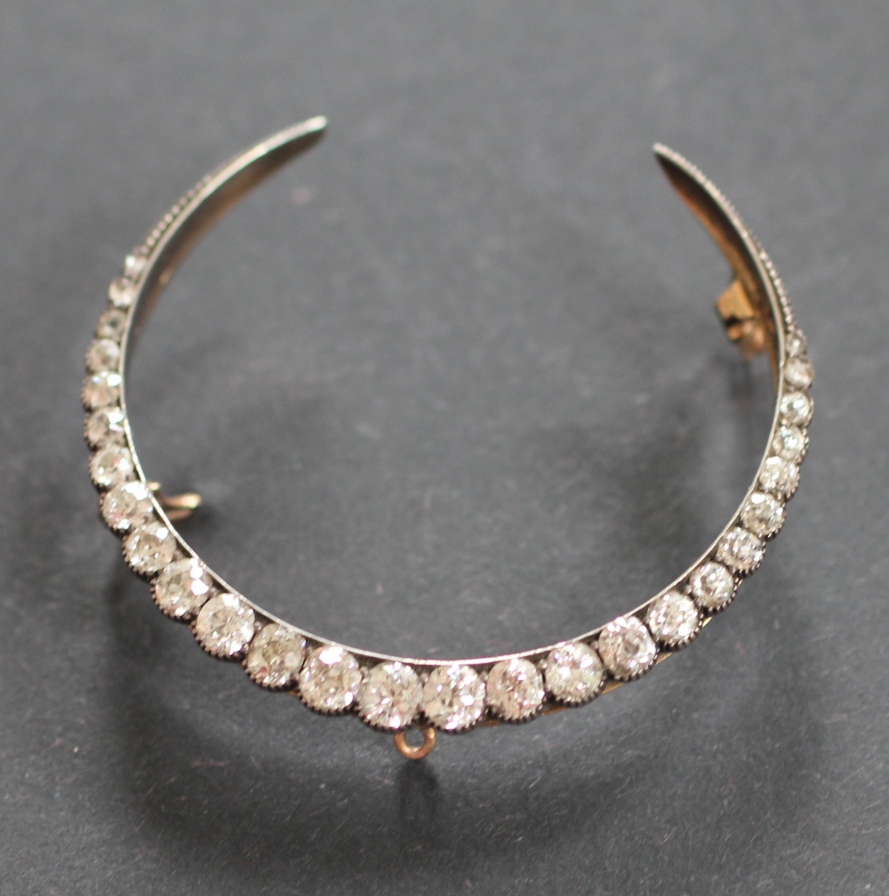 A Victorian diamond set crescent brooch, designed as twenty seven graduated,