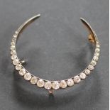 A Victorian diamond set crescent brooch, designed as twenty seven graduated,