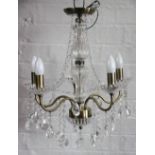 A pair of moulded glass five branch chandeliers, with lustre drops,