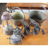 Three brass oil lamps; two preserve pans,