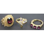 A collection of six gem set rings, to include; a garnet and diamond ring set in 18k,