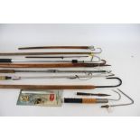 A collection of salmon gaffs, rod rests, salmon tailers, reels,