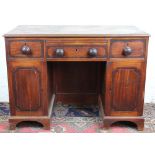 An early 19th century cross-banded mahogany pedestal desk,